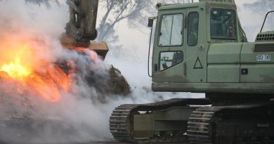 Australian Army engineers were swiftly redeployed 100km north from Cooma to Canberra in response to the Canberra fires on January 23rd. following a call from the ACT’s Emergency Services Agency. A bulldozer, excavator and grader were quickly loaded onto trucks and sent forward to the emergency zone. in this photo, Sapper Mathias Beddie, from the 2nd Combat Engineer Task Group – NSW, pulls-down piles of burning mulch so that bulldozers and graders can spread it for firefighters to douse with water. The piles are too dense to extinguish without first being spread and would otherwise smoulder for weeks and remain a fire hazard. Photo by Major Cameron Jamieson.