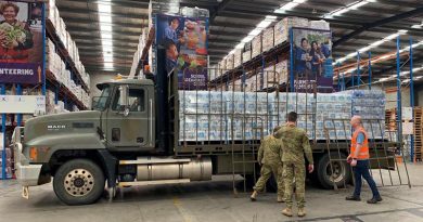 Soldiers from 15 Force Support Squadron load pallets of water at the Foodbank Victoria warehouse in Melbourne. Photo by Corporal Sebastian Beurich.