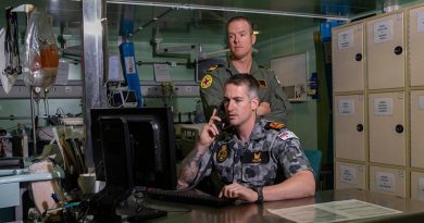 Embarked nursing officers Lieutenant Commander Thomas Miller (front) and Lieutenant Travis Robinson in HMAS Adelaide's treatment room. Photo by Able Seaman Thomas Sawtell.