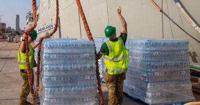 Cargo specialists Private Travis Elliot and Private Eboni Fraser load pallets of fresh water onto HMAS Adelaide at Fleet Base East, Sydney, in preparation to sailing as part of Operation Bushfire Assist 19-20. Photo by Able Seaman Benjamin Ricketts.