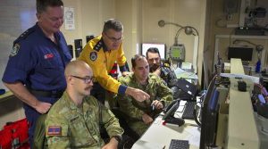 Amphibious Task Group and embeds work together onboard HMAS Adelaide.