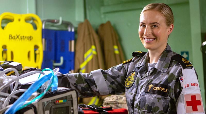 Leading Seaman Medic (Underwater) Kiah Chapple prepares medical equipment in the flight deck triage onboard HMAS Adelaide. Photo by Able Seaman Thomas Sawtell.