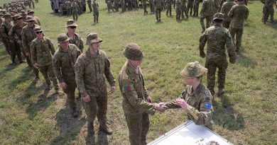 Lieutenant Colonel Renee Kidson, commanding officer of the 5th Engineer Regiment Task Group, hands out lapel pins to soldiers at the old Bega racecourse. The task group’s mission was to relieve fire-affected communities and assist civil response on the New South Wales south coast from Nowra to the Victorian boarder. Photo by Sergeant Max Bree.