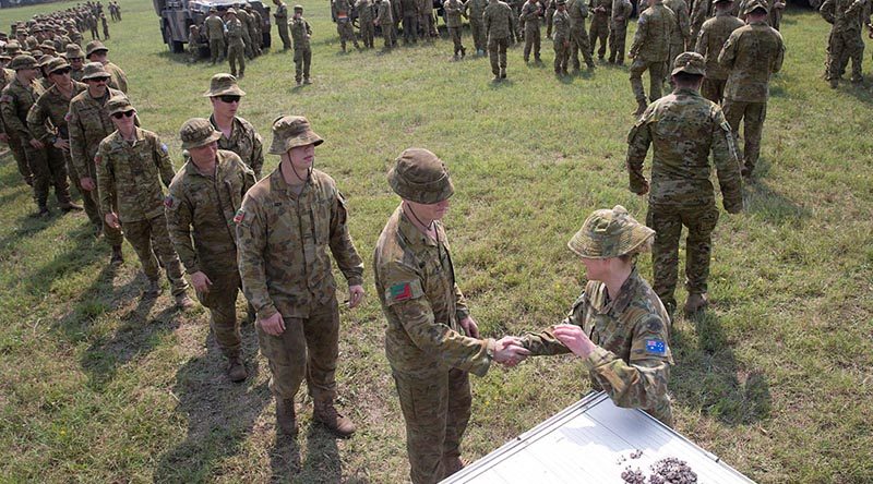 Lieutenant Colonel Renee Kidson, commanding officer of the 5th Engineer Regiment Task Group, hands out lapel pins to soldiers at the old Bega racecourse. The task group’s mission was to relieve fire-affected communities and assist civil response on the New South Wales south coast from Nowra to the Victorian boarder. Photo by Sergeant Max Bree.