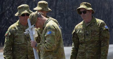 Lieutenant Kynan Lang from the 10th/27th Battalion, RSAR, is supported by colleagues at the place where his uncle and cousin died in a bushfire on Kangaroo, before placing a memorial in their honour. Photo by Corporal Tristan Kennedy.