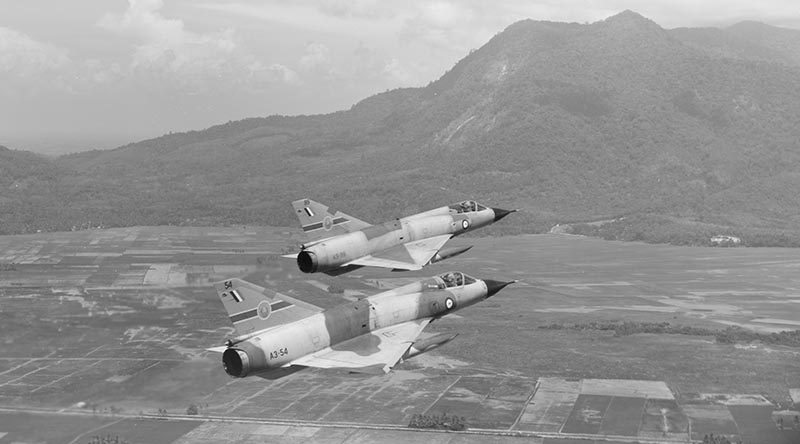 Two Australian Mirage fighters from 79 Squadron over land near Butterworth. RAAF photo.
