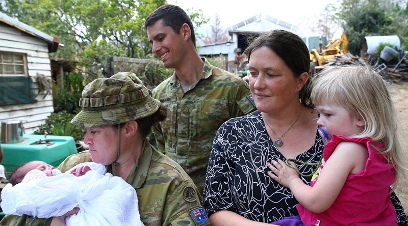 Corporal Kristie Connell, of the 8th Combat Service Support Battalion, and Private Nicholas Brimmer, of the 2nd/17th Battalion, Royal New South Wales Regiment, with Sarah and Ruby Tyrrell and baby Ivy. Photo by Sergeant Max Bree.