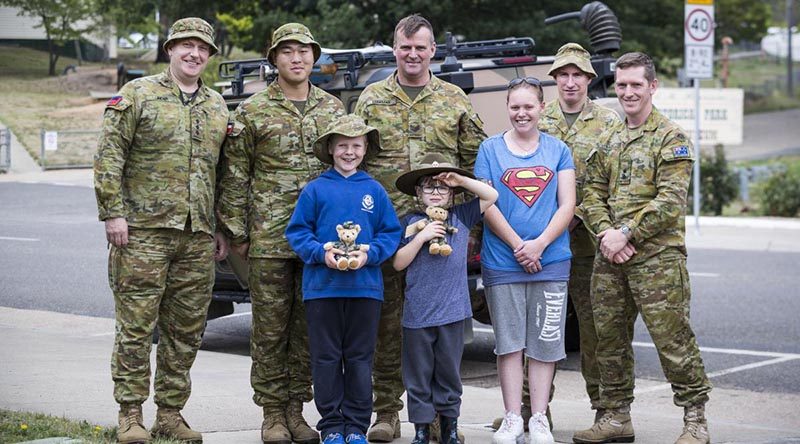Chaplain Phil Linden, Lieutenant Henry Vong, Sergeant Glenn Ludeman, Warrant Officer Class One Anthony Jones and Lieutenant Colonel Daniel Strack with Omeo locals Jackson, Ryan and Rebecca, back home in Omeo. Photo by Corporal Sebasitan Beurich.