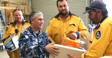 Corporal Shane Watts from 65 Squadron delivers meals and soft drinks to RFS volunteers in the fire grounds. Photo and story by Major Cameron Jameison.