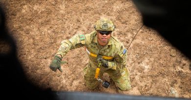 Australian Army Private Tauiliili from the 7th Battalion, Royal Australian Regiment, signals he is secure and ready to be winched up to a New Zealand Air Force NH90 helicopter in Canberra during Operation Bushfire Assist 19-20. Photo by Major Cameron Jamieson.