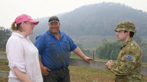 Dairy farmer Tim Salway and his wife Leanne chat with Australian Army officer Lieutenant Aiden Frost on their family farm. Photo by Sergeant Max Bree.