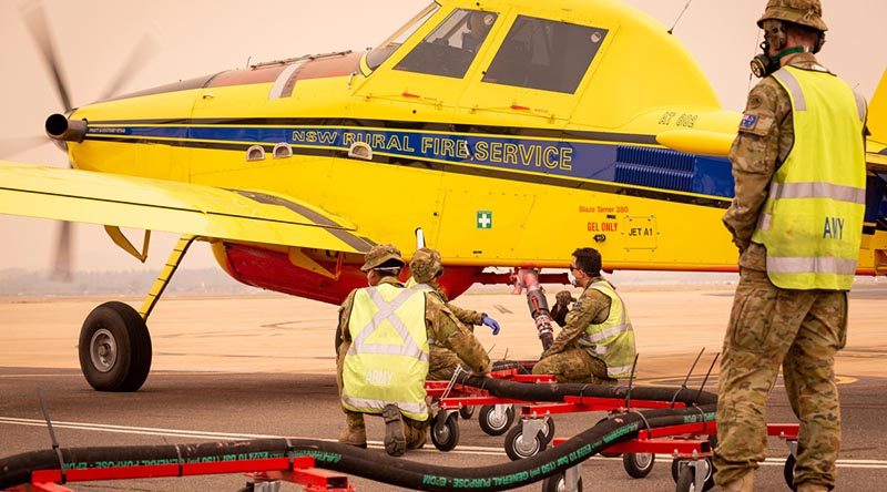 Soldiers from the 1st/19th Battalion, Royal New South Wales Regiment, refill fire retardant solution for a New South Wales Rural Fire Service plane in Canberra during Operation Bushfire Assist 19-20. Photo by Signalman Robert Whitmore.