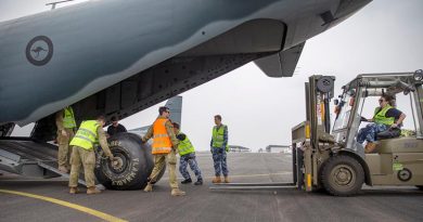 Australian Army and Royal Australian Air Force personnel work together to load a diesel fuel bladder to for Mallacoota power station onto a RAAF C-27J Spartan at RAAF Base East Sale during Operation Bushfire Assist 19-20. Photo by Corporal Nicole Dorrett.