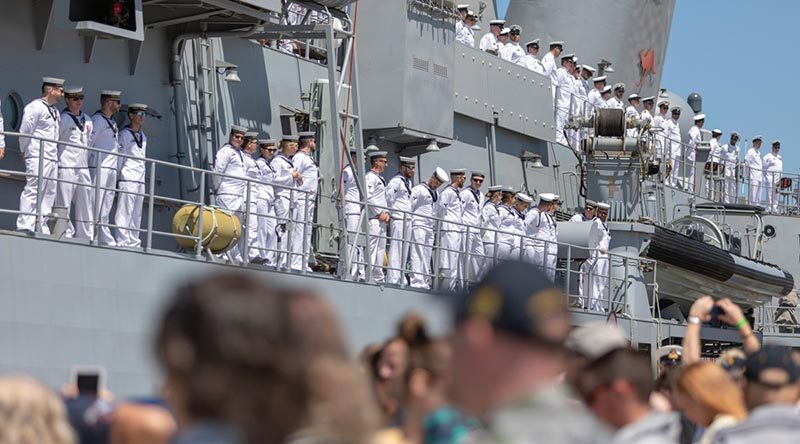 Officers and sailors on HMAS Toowoomba line the upper decks as to farewell family, friends and colleagues as the ship departs for Operation Manitou from Fleet Base West, Western Australia. Photo by Leading Seaman Ronnie Baltoft.