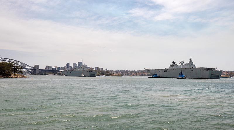 HMAS Adelaide returns home to Fleet Base East in Sydney after taking part in Operation Bushfire Assist 19-20, while HMAS Canberra prepares for a starring role in Australian Day celebrations near the Sydney Harbour Bridge. Photo by Leading Seaman Chris Szumlanski.