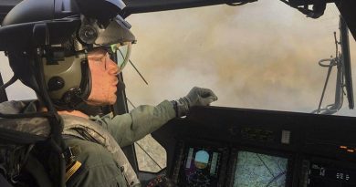 Royal Navy Pilot Lieutenant Commander Nick Grimmer in an 808 Squadron MRH90 Taipan helicopter over the Grose Valley bushfire in the Blue Mountains National Park. Photo by Chief Petty Officer Brett Kennedy.