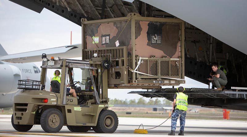 No. 23 Squadron air movements personnel load an Australian Army 6th Engineer Support Regiment water purification system on to a C-17A Globemaster at RAAF Base Amberley, destined for Kangaroo Island off South Australia. Photo: Corporal Jessica de Rouw.