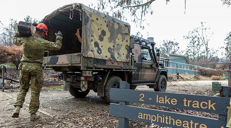 Corporal Travis Ward, 6RAR, loads a G-Wagon with debris at the Eurobodalla Regional Botanic Gardens, NSW. Photo by Corporal Dan Pinhorn.