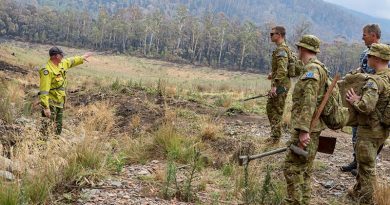 Soldiers from 6RAR are briefed by Scott Seymour from the ACT Environmental Services Agency before laying sediment traps in water-flow lines of the Corin Dam catchment in Namadgi National Park during Operation Bushfire Assist. Photo by Corporal Dan Pinhorn.