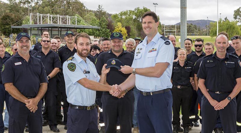 ADFA Director Education and Training Group Captain Jeff Howard presents Queensland Fire and Emergency Services officer Sam Eitz with an ADFA cap as a token of friendship before ADFA's firefighter-guests left for home. Photo by Corporal Dan Pinhorn.