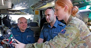 Australian Army Reservist Private Sam Cantle, a combat medical attendant with the Sydney-based 5th Combat Services Support Battalion gives familiarisation tips on the Bushmaster ambulance vehicle to ACT Ambulance Service officers John Berry (left) and Paul Haines at Fairbairn, Canberra. Photo by Sergeant Dave Morley.