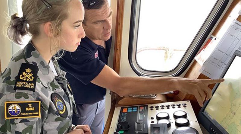 An Australian Navy Cadet at the helm of an Australian Maritime College training vessel during the inaugural ANC Maritime Skills Camp.
