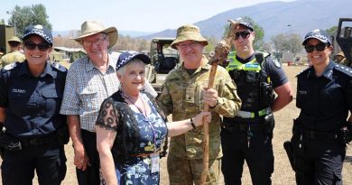 Police Chaplain Carol Allen presents the shepherd's crook to Chaplain Robert Packer, flanked by Ian Post, second from left, and members of Victoria Police. Photo by Private Stuart Rayner.