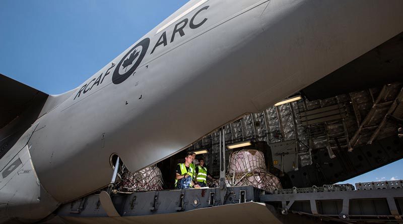 RAAF No 22 Squadron Air Movements Section personnel prepare to unload fire retardant from a Royal Canadian Air Force CC-177A Globemaster III at RAAF Base Richmond during Operation Bushfire Assist. Photo by Corporal David Said.