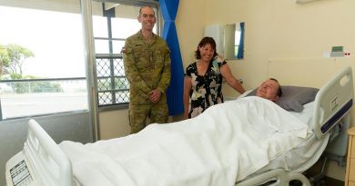 Chaplain Derek Croser with Jodie Meikle, Steven Childs – and 'the bed'.