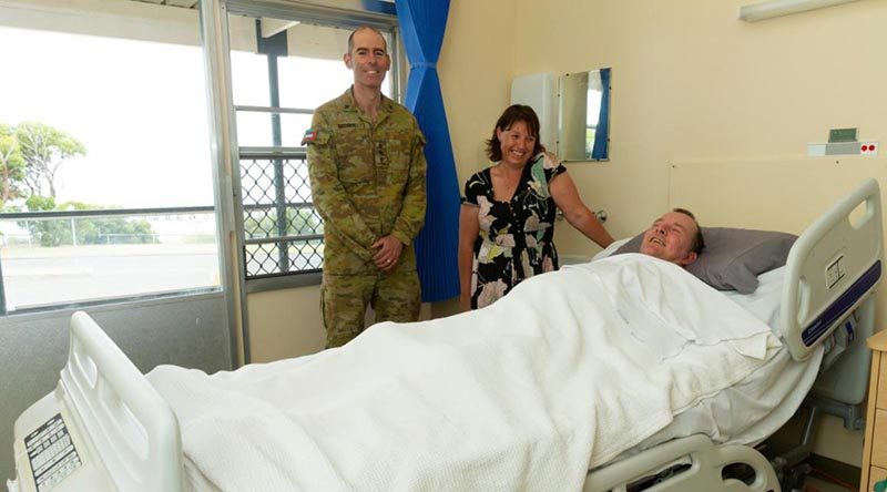 Chaplain Derek Croser with Jodie Meikle, Steven Childs – and 'the bed'.