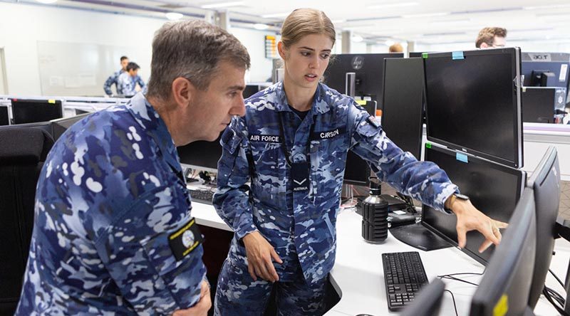 Air Commander Australia Air Vice Marshal Joe Iervasi is briefed by Leading Aircraftwoman Tori-Lee Carson at Distributed Ground Station - Australia during a visit to RAAF Base Edinburgh to meet with units and personnel supporting Operation Bushfire Assist. Photo by Leading Aircraftwoman Jacqueline Forrester.