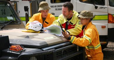 Ambulance Commander Joel Powell (centre), from the ACT Ambulance Service, discuss firefighting operations with Lance Corporal Matt Fegeleson, while Lance Corporal Jessica Zhang monitors emergency services radio traffic, in the Brindabella Ranges. Together they form a remote-area ambulance team, using a six-wheel drive Army G-Wagon ambulance, to support an ACT Rural Fire Service strike team operating in remote woodlands. Photo by Major Cameron Jamieson.