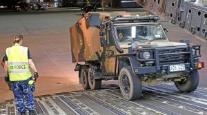 One fo two Australian Army G-Wagon ambulances from Brisbane-based 1st Close Health Battalion reverses off a Royal Australian Air Force C-17 Globemaster for tasking during Canberra's State of Emergency. Photo by Sergeant Dave Morley.