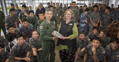 Jan-Maree Ball, of Aussie Hero Quilts, presents Colonel Ota Masashi with a laundry bag at a farewell barbecue for members of the Japan Self-Defense Force. All contingent members were presented with the Aussie Hero Quilts special gift. Photo by Corporal Casey Forster.