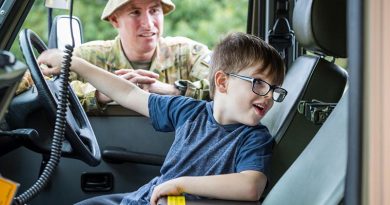 Regimental Sergeant Major 5th/6th Battalion, Royal Victorian Regiment, Warrant Officer Class One Anthony Jones watches as Omeo local Ryan checks out a Mercedes G-Wagon. Photo by Corporal Sebastian Beurich.