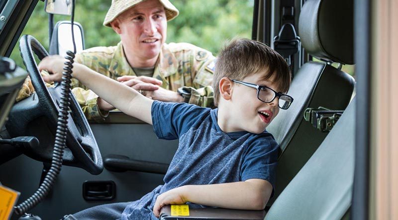 Regimental Sergeant Major 5th/6th Battalion, Royal Victorian Regiment, Warrant Officer Class One Anthony Jones watches as Omeo local Ryan checks out a Mercedes G-Wagon. Photo by Corporal Sebastian Beurich.