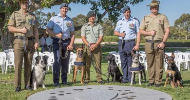 Australian Army Sergeant Stuart Conlin with Trip, RAAF Leading Aircraftman Gregory Chance with Veda, New Zealand Army Lance Corporal Maylin Broderick with Flicka, RAAF Leading Aircraftman Bradley Evans with Ollie and Australian Army Sapper Luke Saxton with Mate, at the new Military Working Dogs Memorial in Canberra. Photo by Leading Seaman Kylie Jagiello.