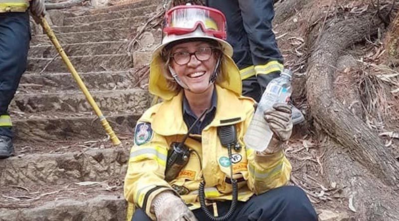 Squadron Leader Del Gaudry takes a rest from the front line in her other role as a volunteer firefighter, in the Blue Mountains.