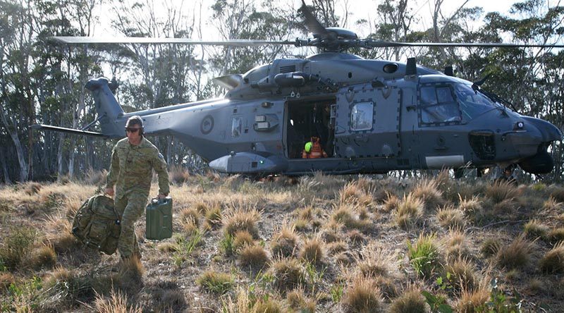 Sergeant Joshua Howlett carries equipment from a 3 Squadron, Royal New Zealand Air Force, NH-90 helicopter in Namadgi National Park, west of Canberra city. Photo by Major Cameron Jamieson.