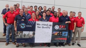 Staff from TAE Aerospace (blue shirts) and Pratt & Whitney (red) celebrate the first F135 maintenance outside the USA, in Queensland. Photo supplied by TAE Aerospace.