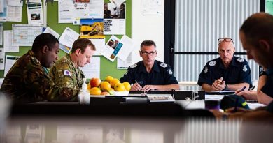 Captain Levi, of the PNG Defence Force, and Lieutenant Scott Bowers in a meeting with members of Victoria Police at the Swift Creek Incident Control Centre during Operation Bushfire Assist. Photo by Private Madhur Chitnis.