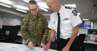Emergency Management Victoria’s Commissioner Andrew Crisp discusses operations in south-east Victoria with Colonel Michelle Campbell at the State Control Centre in Melbourne. Photo by Major Cameron Jamieson.