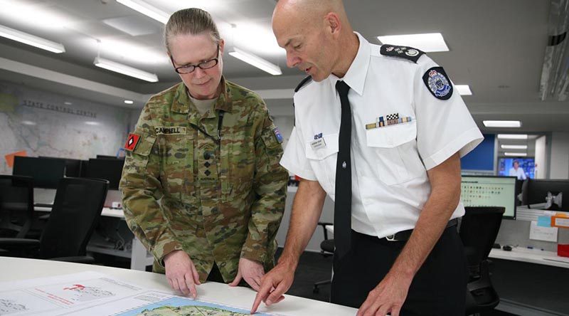 Emergency Management Victoria’s Commissioner Andrew Crisp discusses operations in south-east Victoria with Colonel Michelle Campbell at the State Control Centre in Melbourne. Photo by Major Cameron Jamieson.