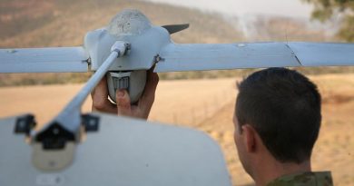 Gunner Scott Fressand, 20th Regiment, Royal Australian Artillery, prepares to launch a Wasp III drone. The aircraft is being used to monitor spot fires in the Tharwa, ACT, area in the early morning when helicopters are not operating. Integrated into the massive ACT Emergency Services Agency’s intelligence collection capabilities, the small reconnaissance aircraft is fitted with an infrared video camera, ideal for looking at bushfires. Photo by Major Cameron Jamieson.