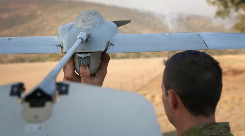 Gunner Scott Fressand, 20th Regiment, Royal Australian Artillery, prepares to launch a Wasp III drone. The aircraft is being used to monitor spot fires in the Tharwa, ACT, area in the early morning when helicopters are not operating. Integrated into the massive ACT Emergency Services Agency’s intelligence collection capabilities, the small reconnaissance aircraft is fitted with an infrared video camera, ideal for looking at bushfires. Photo by Major Cameron Jamieson.