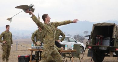 Bombardier Jarrod Logan launches a Wasp AE from a paddock 20km south of Canberra to survey blazing scrub in the Orroral Valley. Photo by Corporal Julia Whitwell.