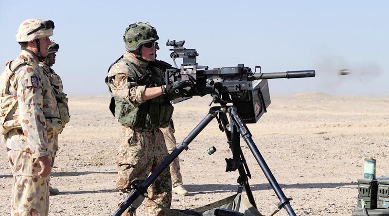 Warrant Officer Class 2 Brett Donaldson, ‘A’ Field Battery, supervises a Danish soldier firing a Heckler and Koch grenade machine gun during a range practice at Forward Operating Base Budwan, Helmand Province Afghanistan. Photo by Corporal Raymond Vance.