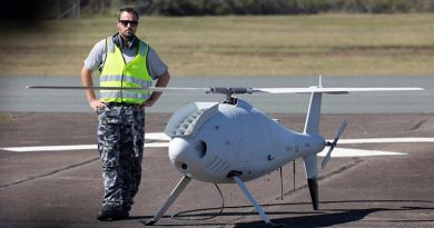 Petty Officer Aviation Technician Avionics Rodney Ferreira, stands by the Schiebel S-100 Camcopter before a flight at Jervis Bay airfield. Photo by Chief Petty Officer Cameron Martin.