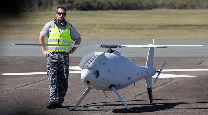 Petty Officer Aviation Technician Avionics Rodney Ferreira, stands by the Schiebel S-100 Camcopter before a flight at Jervis Bay airfield. Photo by Chief Petty Officer Cameron Martin.