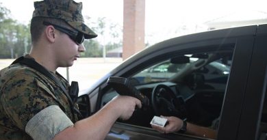 A US Marine Corps gate sentry demonstrates how sentries at entry control points will limit physical contact in the fight against COVID-19. US Marine Corps photo by Lance Corporal Taylor Smith.